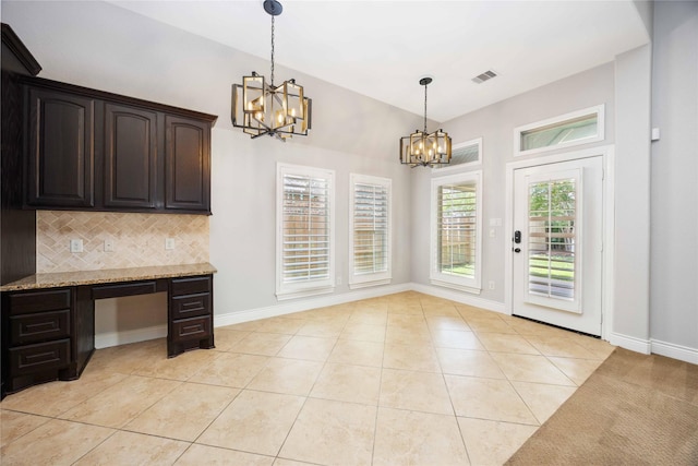 2423 Rosillos Peak Dr, Spring, TX 77386 - unfurnished dining area featuring a chandelier, light tile patterned flooring, and baseboards