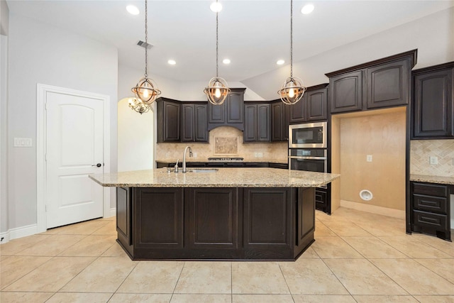 2423 Rosillos Peak Dr, Spring, TX 77386 - kitchen with stainless steel appliances, tasteful backsplash, light stone counters, and recessed lighting