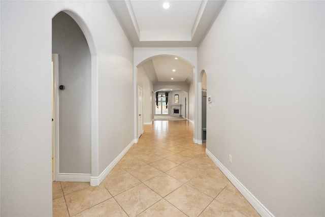 2423 Rosillos Peak Dr, Spring, TX 77386 - hallway featuring arched walkways, light tile patterned floors, recessed lighting, and baseboards
