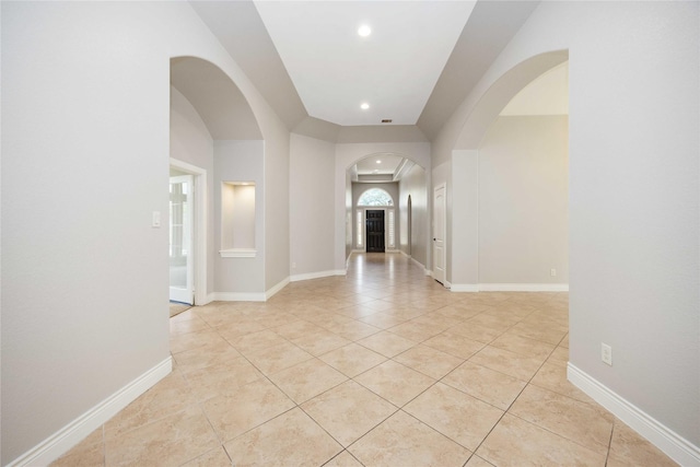 2423 Rosillos Peak Dr, Spring, TX 77386 - spare room featuring arched walkways, light tile patterned floors, recessed lighting, and baseboards