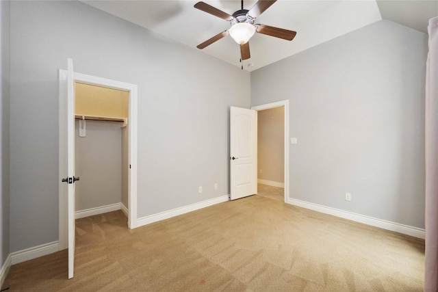 2423 Rosillos Peak Dr, Spring, TX 77386 - unfurnished bedroom with light carpet, vaulted ceiling, a spacious closet, baseboards, and a ceiling fan