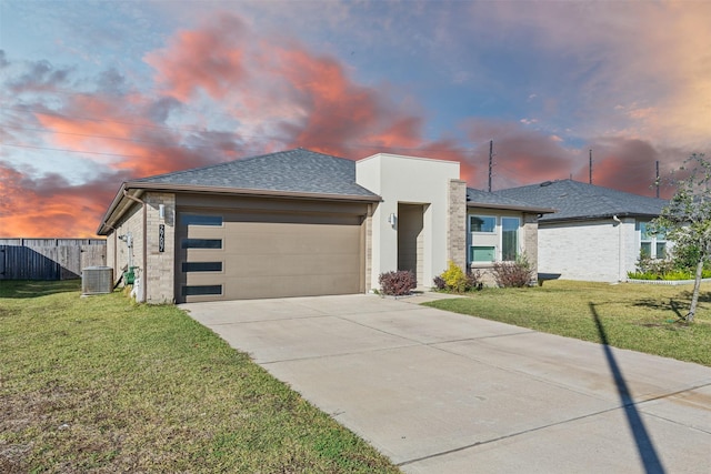 29607 Ella Larchmont Ct, Katy, TX 77494 - view of front of home featuring a yard, fence, an attached garage, a shingled roof, and concrete driveway