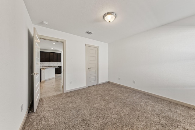 29607 Ella Larchmont Ct, Katy, TX 77494 - unfurnished bedroom with light tile patterned floors, light colored carpet, visible vents, recessed lighting, and baseboards