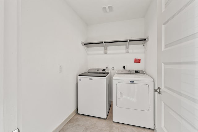 29607 Ella Larchmont Ct, Katy, TX 77494 - laundry room with laundry area, light tile patterned floors, visible vents, baseboards, and washing machine and dryer