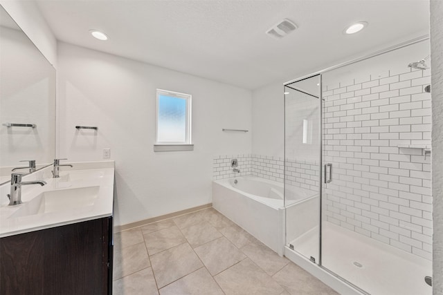 29607 Ella Larchmont Ct, Katy, TX 77494 - bathroom featuring a garden tub, visible vents, a sink, a stall shower, and baseboards