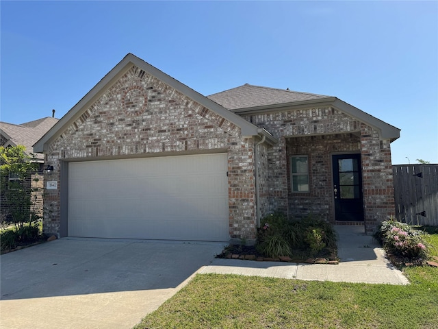 view of front facade featuring a garage, brick siding, and driveway