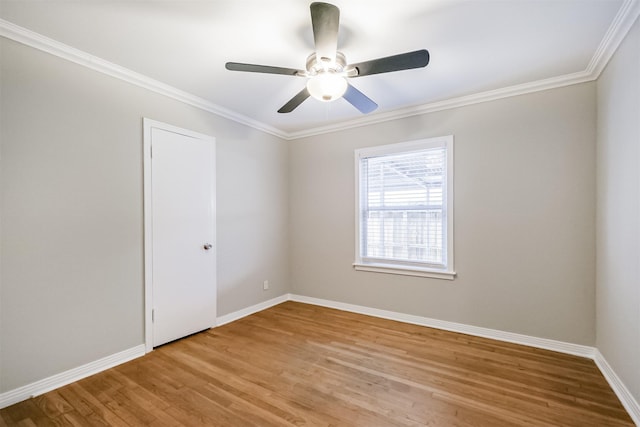 unfurnished room with crown molding, light wood finished floors, baseboards, and a ceiling fan