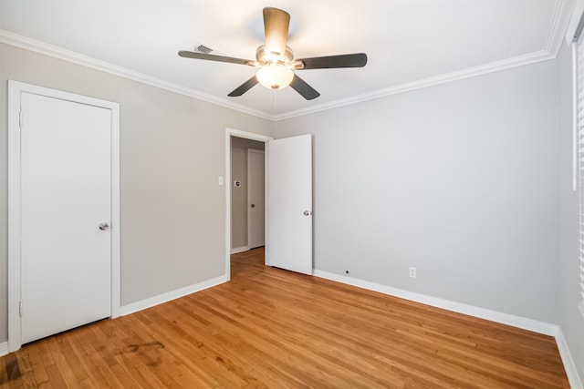 unfurnished bedroom featuring light wood finished floors, baseboards, ornamental molding, and visible vents