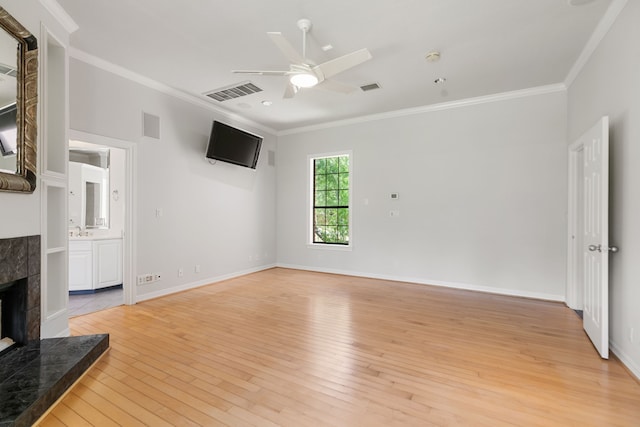 unfurnished living room featuring crown molding, light wood finished floors, a ceiling fan, and visible vents