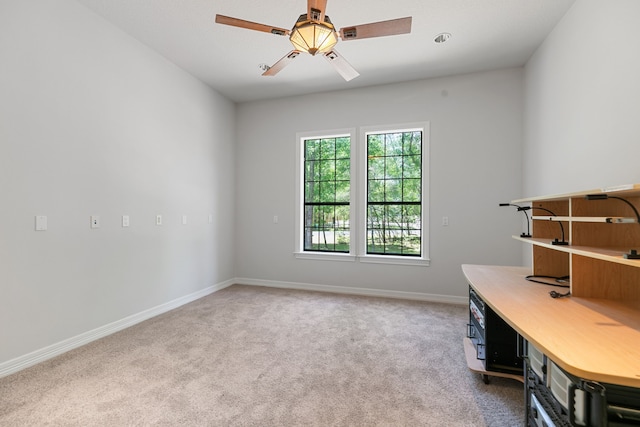 office space featuring carpet flooring, baseboards, and a ceiling fan