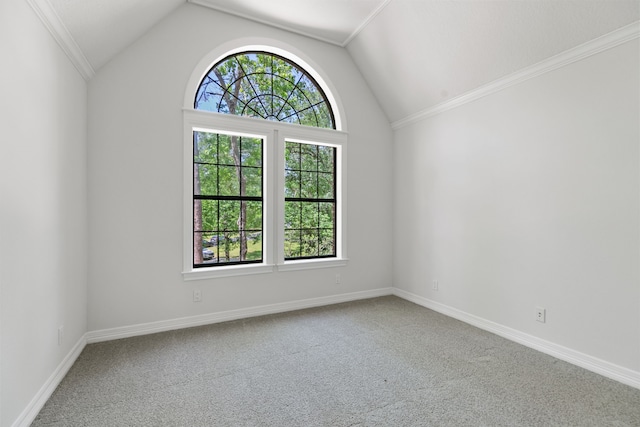 unfurnished room with carpet, baseboards, ornamental molding, and lofted ceiling