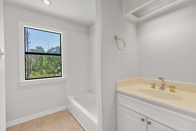 bathroom with tile patterned floors, vanity, and baseboards