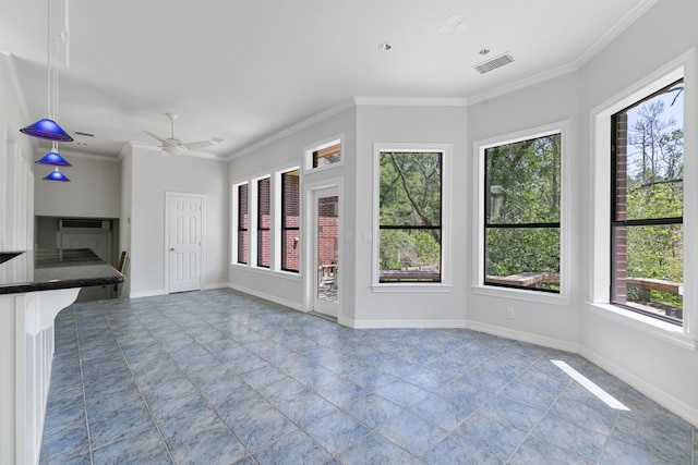 unfurnished living room with ornamental molding, visible vents, and a wealth of natural light