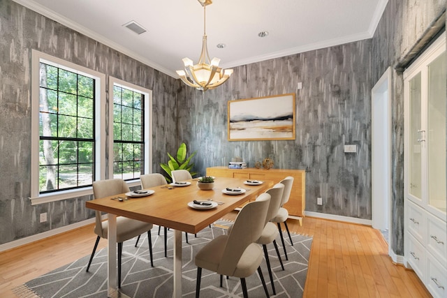 dining space with plenty of natural light, visible vents, an inviting chandelier, and light wood-style flooring