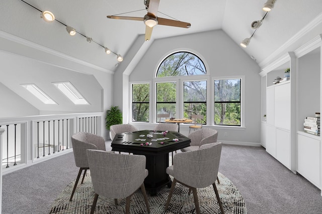 dining space featuring crown molding, ceiling fan, light colored carpet, lofted ceiling, and baseboards
