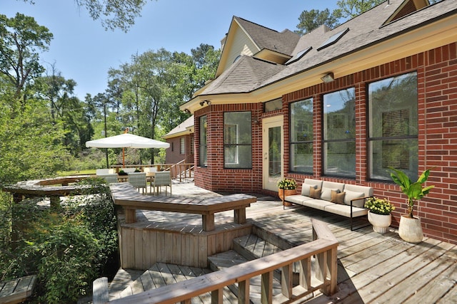 wooden terrace featuring outdoor dining space and an outdoor living space