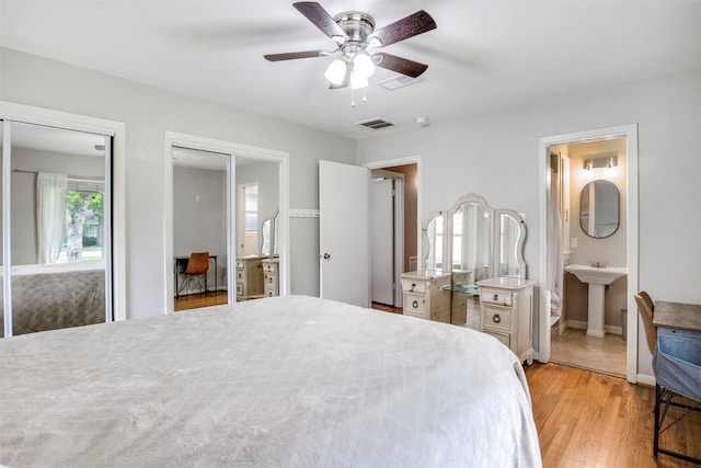 3703 Peppermill Rd, Houston, TX 77080 - bedroom with light wood-style flooring, multiple closets, connected bathroom, a sink, and ceiling fan