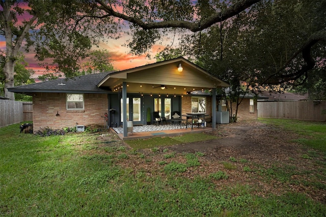 3703 Peppermill Rd, Houston, TX 77080 - back of property at dusk featuring brick siding, a patio, and ceiling fan