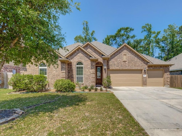 single story home with brick siding, an attached garage, driveway, and a front lawn