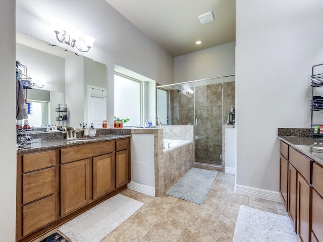 bathroom featuring a shower stall, two vanities, a garden tub, and tile patterned flooring