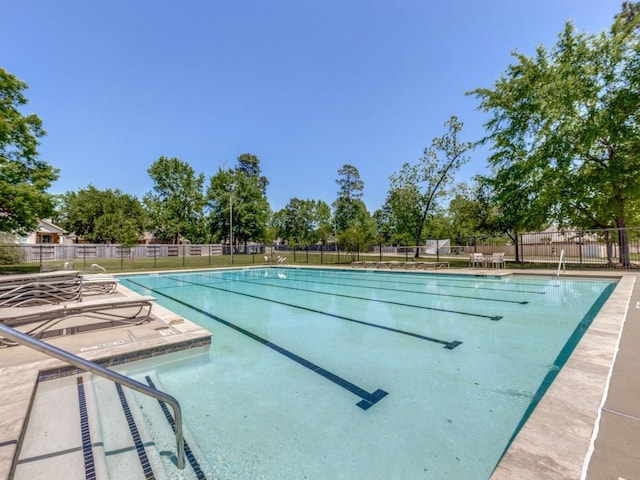 community pool featuring a patio area and fence