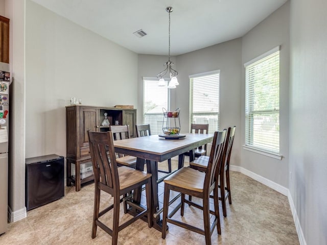 2054 Brookmont Dr, Conroe, TX 77301 - dining area featuring a chandelier, baseboards, and light tile patterned flooring