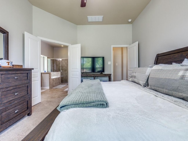 bedroom featuring visible vents, ceiling fan, connected bathroom, wood finished floors, and lofted ceiling