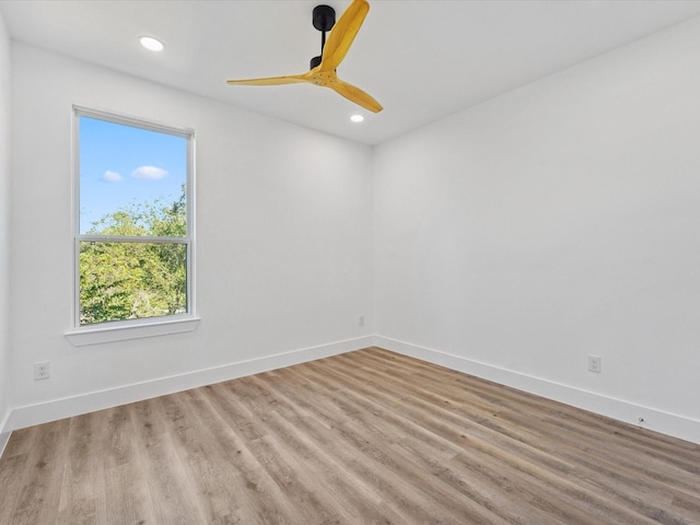 empty room featuring recessed lighting, baseboards, and wood finished floors