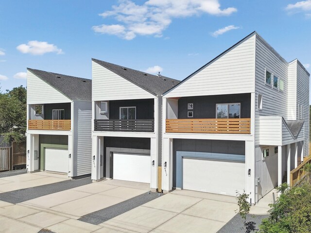 view of front of house with concrete driveway and an attached garage