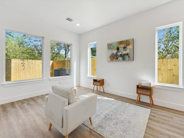 sitting room featuring wood finished floors, baseboards, visible vents, and recessed lighting
