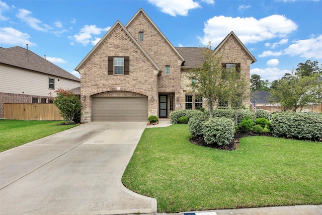 404 Christians Ct, Montgomery, TX 77316 - view of front of house featuring fence, concrete driveway, an attached garage, brick siding, and a front yard