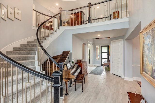 404 Christians Ct, Montgomery, TX 77316 - entryway with a high ceiling, wood finished floors, arched walkways, baseboards, and stairs
