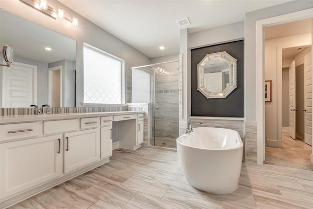 404 Christians Ct, Montgomery, TX 77316 - full bathroom featuring recessed lighting, a freestanding bath, visible vents, vanity, and a stall shower
