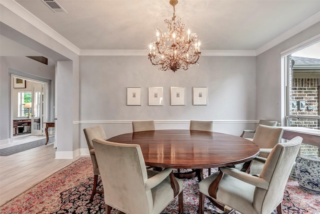 404 Christians Ct, Montgomery, TX 77316 - dining area featuring light wood-type flooring, visible vents, ornamental molding, and a notable chandelier