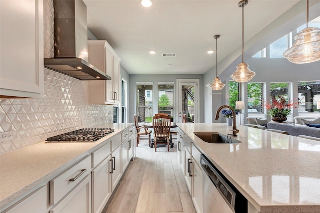 404 Christians Ct, Montgomery, TX 77316 - kitchen with wall chimney exhaust hood, stainless steel appliances, a sink, and plenty of natural light