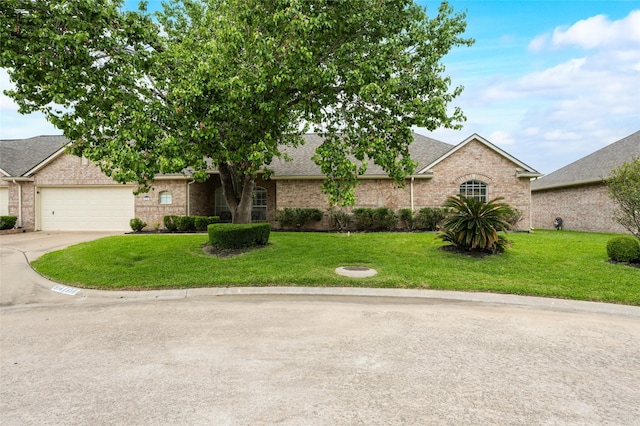 view of front of property with concrete driveway, a front yard, a garage, and brick siding