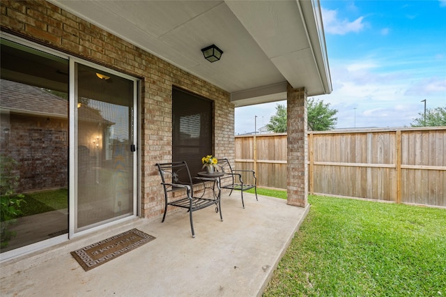 view of patio / terrace featuring fence