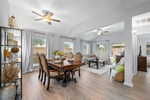 dining room featuring visible vents, ceiling fan, light wood-type flooring, and lofted ceiling