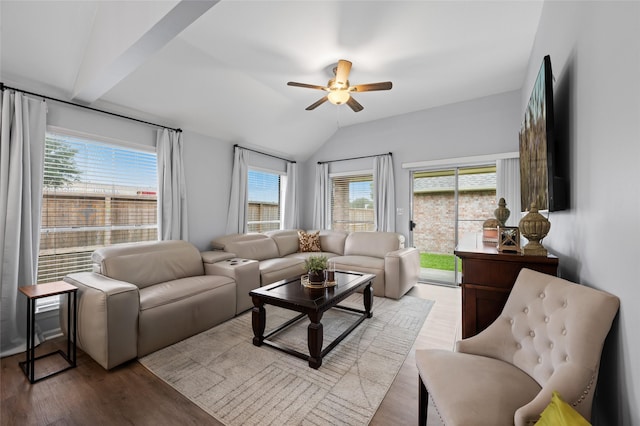 living area featuring wood finished floors, vaulted ceiling, and ceiling fan