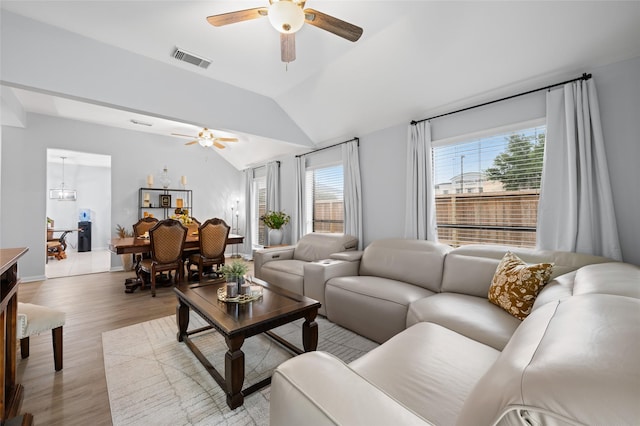 living room featuring visible vents, ceiling fan, light wood-type flooring, and lofted ceiling