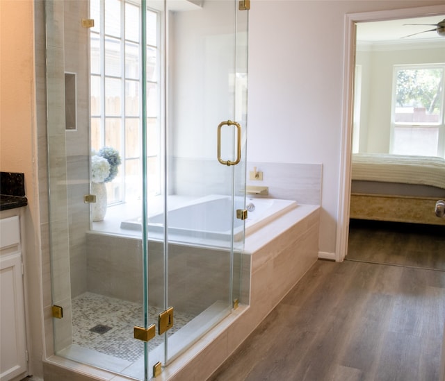 3222 Serene Oak Dr, Sugar Land, TX 77478 - full bathroom featuring wood finished floors, a stall shower, a ceiling fan, a garden tub, and vanity