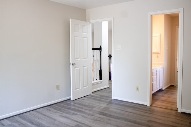 3222 Serene Oak Dr, Sugar Land, TX 77478 - unfurnished bedroom featuring wood finished floors, baseboards, and connected bathroom