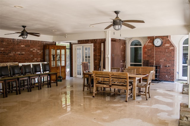 3222 Serene Oak Dr, Sugar Land, TX 77478 - dining area with a ceiling fan and brick wall