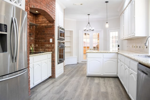 3222 Serene Oak Dr, Sugar Land, TX 77478 - kitchen with black appliances, a sink, crown molding, white cabinets, and a chandelier