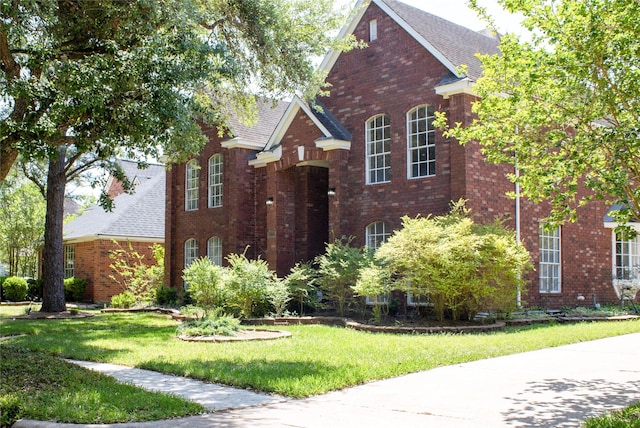 3222 Serene Oak Dr, Sugar Land, TX 77478 - view of front of property featuring brick siding, a front lawn, and a shingled roof