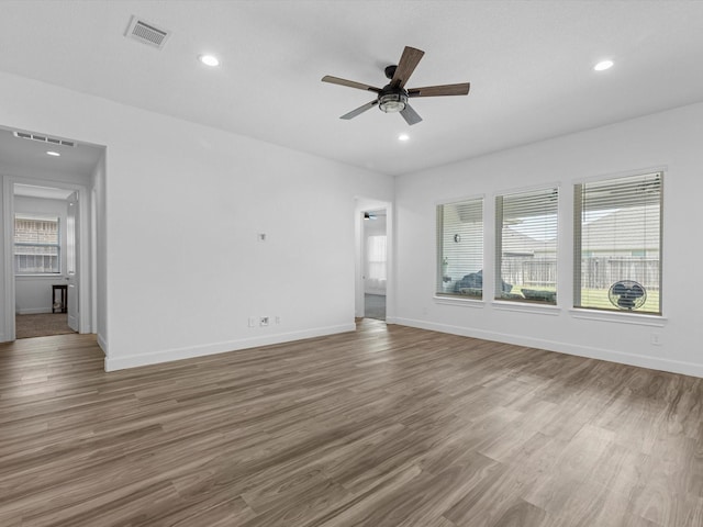 interior space featuring recessed lighting, visible vents, a ceiling fan, and wood finished floors
