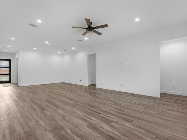 unfurnished room with visible vents, baseboards, a ceiling fan, recessed lighting, and wood finished floors
