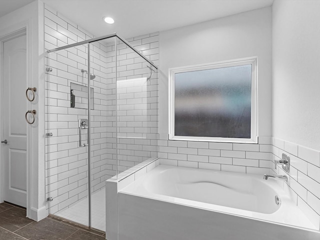 full bathroom featuring a shower stall, a bath, and recessed lighting