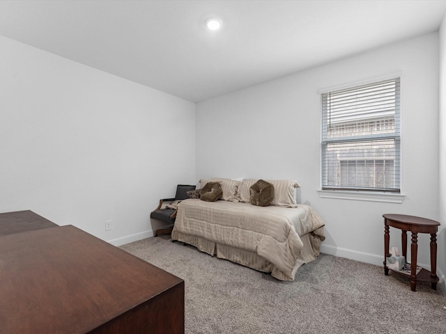 carpeted bedroom featuring baseboards