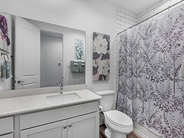 full bathroom featuring vanity, toilet, and wood finished floors